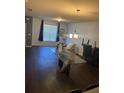 Bright living room with dark wood floors, glass dining table, and stylish decor at 6311 Olmadison Pl, Atlanta, GA 30349