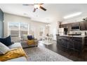 Open-concept living room with lots of natural light and modern decor connecting to the kitchen and dining area at 7701 Haynes Park Pl, Lithonia, GA 30038