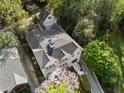 Aerial view of a home with a dark roof, matching garage, and lush greenery at 1503 Emory Ne Rd, Atlanta, GA 30306