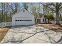 Charming single-story home featuring a well-manicured front yard, attached garage, and inviting entrance at 5882 Riverside Walk Dr, Sugar Hill, GA 30518