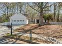 Charming single-story home featuring a well-manicured front yard, attached garage, and inviting entrance at 5882 Riverside Walk Dr, Sugar Hill, GA 30518