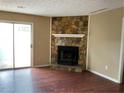 Spacious living room with cozy stone fireplace and sliding door to outdoor space at 6113 Princeton Ave, Morrow, GA 30260