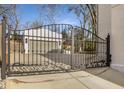 Wrought iron gate provides security and charm, leading to a private driveway and detached garage at 1311 Berwick Ne Ave, Atlanta, GA 30306