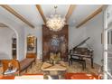 Elegant living room with a decorative fireplace, exposed beam ceilings, and a stylish chandelier at 1311 Berwick Ne Ave, Atlanta, GA 30306