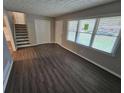 Bright living room featuring new flooring, fresh paint, and ample natural light from large windows at 1968 Copperfield Cir, Decatur, GA 30035