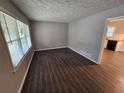 Open living room area with new flooring, fresh paint, and lots of natural light at 1968 Copperfield Cir, Decatur, GA 30035