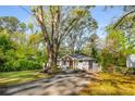 Charming brick home with a welcoming front porch and a long driveway at 2322 Poplar Springs Ne Dr, Brookhaven, GA 30319