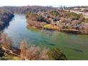 A scenic aerial view features a wide river surrounded by trees and houses at 402 River Vista Dr, Atlanta, GA 30339