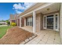 Inviting covered front porch with stone accents and tiled flooring, showcasing curb appeal at 1170 Livery Cir, Lawrenceville, GA 30046