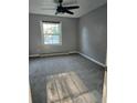 Neutral bedroom featuring natural light, a ceiling fan and gray carpet at 136 Rue Fontaine, Lithonia, GA 30038