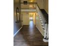 Bright foyer features a staircase with white railings, new floors and neutral paint at 136 Rue Fontaine, Lithonia, GA 30038