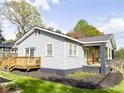 Charming home featuring a wooden deck and a cozy front porch with a swing, perfect for outdoor enjoyment at 1735 Spring Ave, East Point, GA 30344