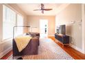 Bright living room with hardwood floors, stylish rug, and a view into the kitchen, perfect for modern living at 1735 Spring Ave, East Point, GA 30344