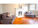 Cozy living room features a decorative fireplace, hardwood floors, and comfortable seating for relaxation at 1735 Spring Ave, East Point, GA 30344