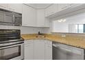 Compact kitchen with stainless steel appliances and granite countertops at 2870 Pharr Court South Nw # 1209, Atlanta, GA 30305