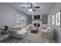 Bright living room features a fireplace, ceiling fan, and neutral finishes at 380 Inman Rd, Fayetteville, GA 30215