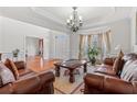 Bright living room featuring hardwood floors, a decorative chandelier, and large windows, ideal for relaxation and Gathering time at 426 Vera Park Pl, Alpharetta, GA 30022