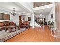 Elegant living room with hardwood floors, coffered ceiling, and open staircase, perfect for gatherings and entertaining at 426 Vera Park Pl, Alpharetta, GA 30022