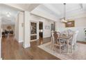Open-concept dining room boasts a statement chandelier, hardwood floors, and seamless flow to other living areas at 432 Horizon Trl, Canton, GA 30114