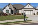 Charming home exterior boasts a manicured lawn, stone accents, and a welcoming, well-landscaped front yard at 432 Horizon Trl, Canton, GA 30114