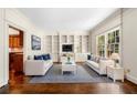 Bright living room featuring hardwood floors, built-in shelving, and an abundance of natural light at 51 Ivy Chase Ne, Atlanta, GA 30342