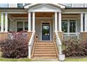 Inviting front porch with classic columns and brick accents, leading to the front door at 1054 Euclid Ne Ave, Atlanta, GA 30307