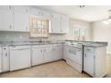 Functional kitchen with white cabinets, granite countertops, and modern appliances at 1512 Daniel Ln, Lawrenceville, GA 30046