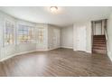 Spacious living room featuring natural light, wood-look floors, and convenient access to the staircase at 1512 Daniel Ln, Lawrenceville, GA 30046