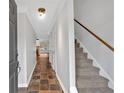 Entryway with tiled floors, stairway, and view into the living area at 3075 Camden Way, Alpharetta, GA 30005