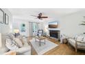 Bright and cozy living room features a stone fireplace, hardwood floors, and comfortable neutral furniture at 4783 Deer Chase, Powder Springs, GA 30127