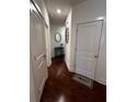 Hallway view showcases hardwood floors, accent table, and 'Home' welcome mat at 61 N Auburn Landing Pl, Auburn, GA 30011