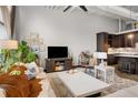 Cozy living room with a large sectional sofa, modern entertainment setup, and an adjacent, well-equipped kitchen area at 5200 Peachtree Rd # 2116, Atlanta, GA 30341