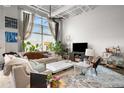 Stylish living room featuring a large window, plants, plush seating, and an open floor plan at 5200 Peachtree Rd # 2116, Atlanta, GA 30341