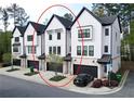 View of stylish new townhomes featuring attached garages and modern architectural details at 1494 Addison Pl, Decatur, GA 30033