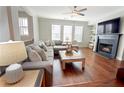 Bright living room boasts hardwood floors, a fireplace, and a comfortable sectional couch at 1494 Addison Pl, Decatur, GA 30033