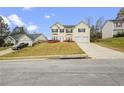 View of house, driveway, and yard, in suburban location at 210 Millpond Pkwy, Villa Rica, GA 30180