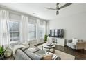 Cozy living room with large windows, comfortable seating, and a ceiling fan at 2420 Lakeshore Se Ln, Atlanta, GA 30316