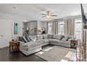Bright living room with a large sectional sofa, neutral colors, and lots of natural light from big windows at 5135 Arnold St, Covington, GA 30014