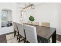 Dining room featuring modern lighting, a dining table with seating for six, and natural light from the window at 139 Rushing View Gln, Dallas, GA 30157