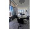 Bright, open dining area with city views through floor to ceiling windows and glass sliding door to a balcony at 285 Centennial Olympic Park Dr # Ph 1-4, Atlanta, GA 30313