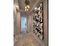 Bright hallway with marble floors, a modern mirror feature wall and a decorative light fixture at 285 Centennial Olympic Park Dr # Ph 1-4, Atlanta, GA 30313