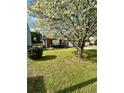 Well-kept front yard with a large tree and blooming flowers in a residential neighborhood at 2895 Dominion Walk Ln, Snellville, GA 30078
