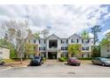 Apartment building with a parking lot and well maintained landscaping, creating an inviting atmosphere at 10104 Fairington Ridge Cir, Lithonia, GA 30038