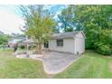 Side view of the charming one-story home with a spacious driveway and lush greenery at 3891 Northstrand Dr, Decatur, GA 30035