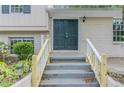Front entrance of the home with a double door, concrete stairs, and white-painted railings at 3891 Northstrand Dr, Decatur, GA 30035