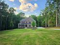 Gorgeous brick home boasts a large, well-maintained front yard in a serene, wooded neighborhood at 7580 Sunridge Ln, Douglasville, GA 30135
