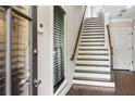 Home foyer features hardwood flooring and a staircase with oak railings at 900 River Vista Dr, Atlanta, GA 30339