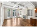 Spacious living room featuring coffered ceilings, a fireplace, and an abundance of natural light at 900 River Vista Dr, Atlanta, GA 30339
