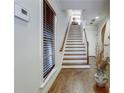 Elegant staircase with hardwood floors and natural light streaming through the window at 900 River Vista Dr, Atlanta, GA 30339