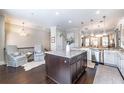 Modern kitchen area featuring a central island, stainless steel appliances, and pendant lighting at 1384 Doublegate Dr, Brookhaven, GA 30319